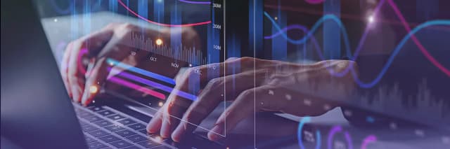 Hands typing on a laptop with overlaid glowing analytics charts, graphs, and data visualizations representing digital finance and technology.