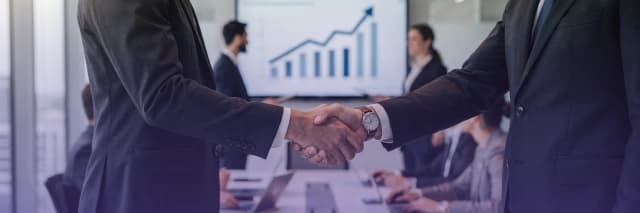 Business executives shaking hands during a corporate meeting, symbolizing partnership, trust, and business growth strategy