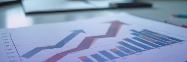 Business performance report showing upward growth trends with a line graph and bar chart illustrating revenue and metric increases over time