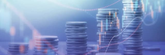 Stacks of coins gradually increasing in height with faint financial graphs overlaid, symbolizing investment growth and economic analytics.