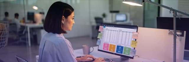 Business analyst reviewing sales tax data and financial metrics on a dashboard with multiple tax rate notes and performance charts.
