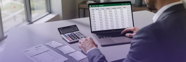 Business professional calculating sales tax and reviewing tax reporting spreadsheet on a laptop with receipts and calculato