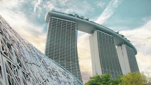 A tall building with a clock on its facade, towering over the city skyline.