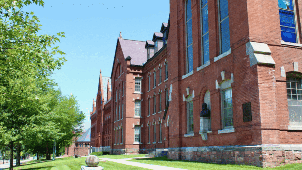 A large brick building with arched windows and a clock tower