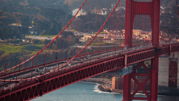 Golden Gate Bridge in San Francisco, showcasing its orange-red color against a clear blue sky.