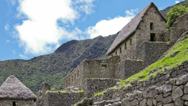 Ancient ruins of Machu Picchu nestled in the Andes, showcasing stunning stone structures and lush green surroundings.